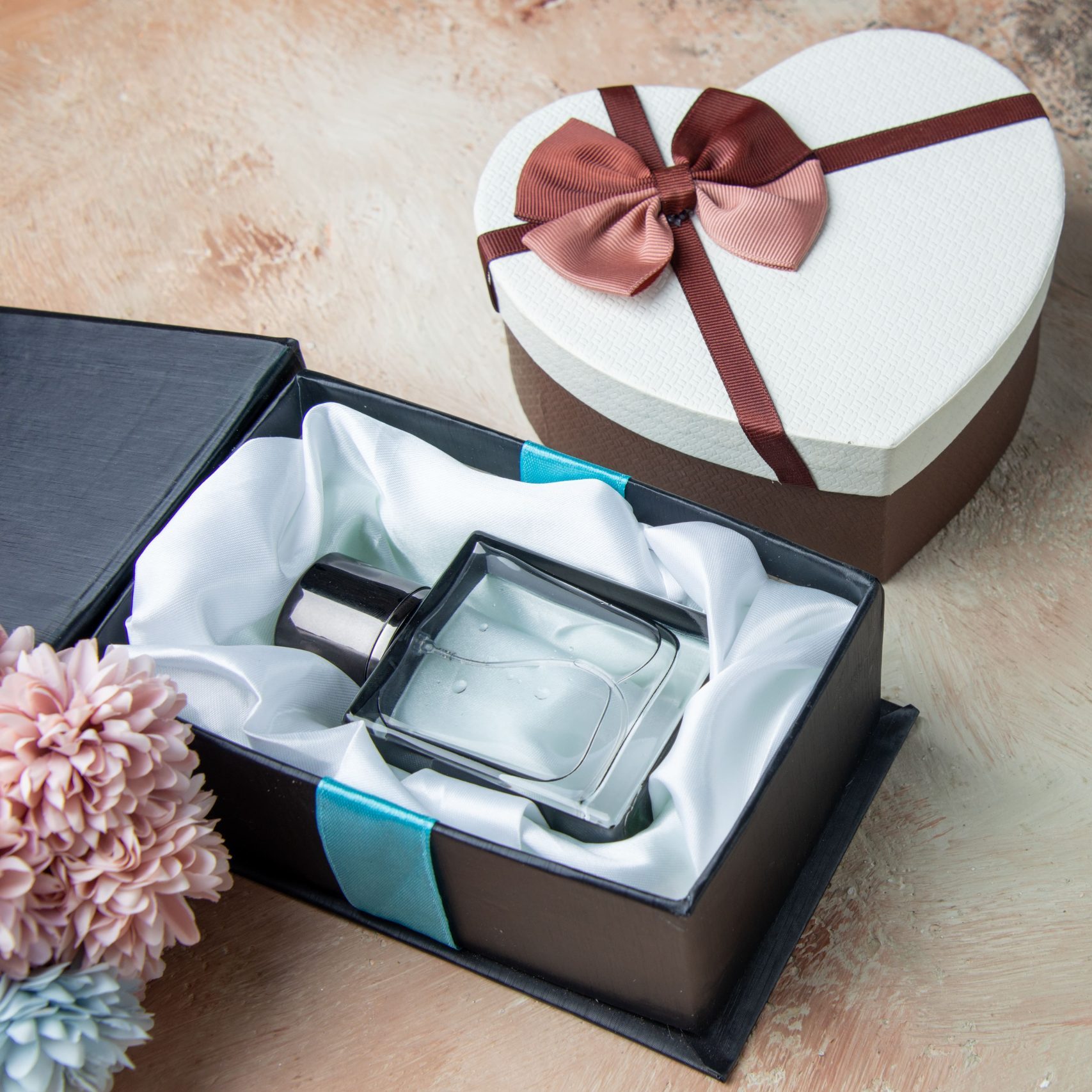 bottom-view-men-cologne-box-heart-shaped-box-flowers-table-min