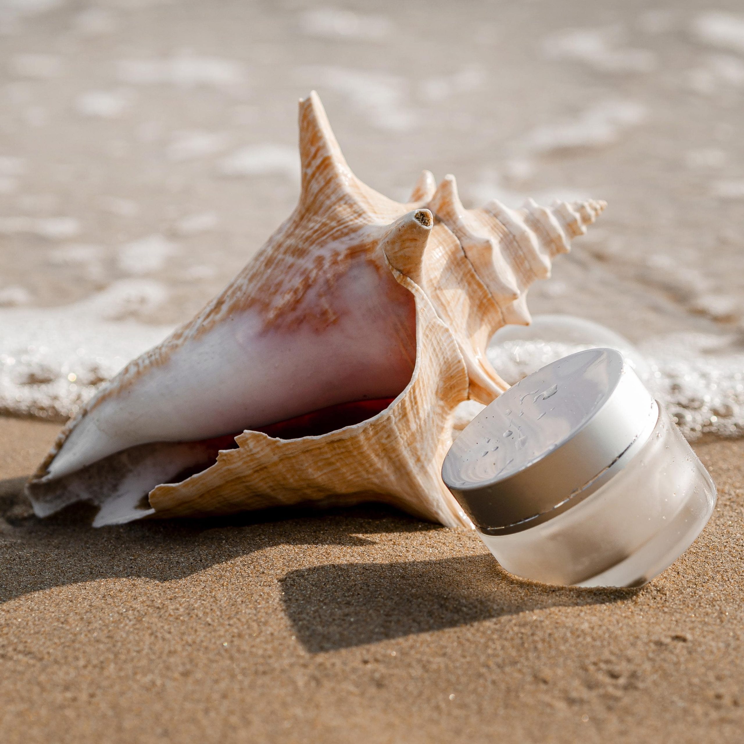transparent-skin-care-moisture-recipient-arrangement-seashell-min
